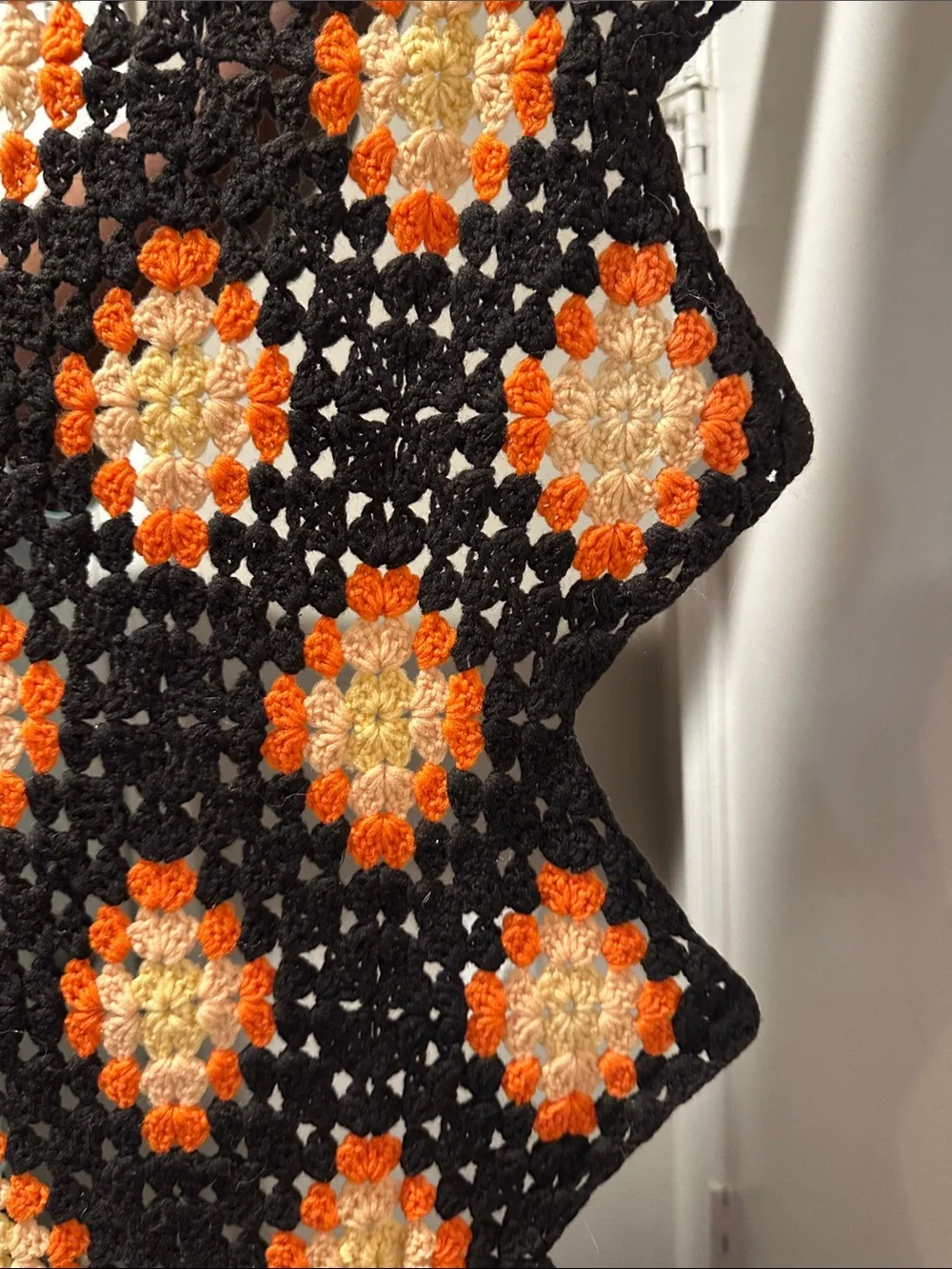 Granny Square black with orange crochet blanket with zig zag hem